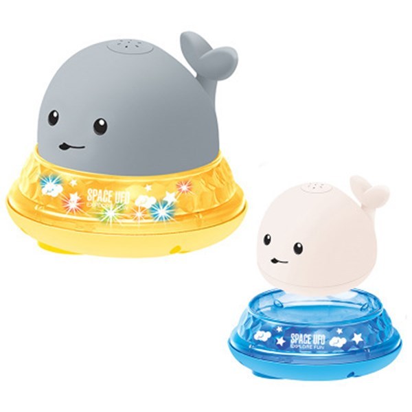 Baby playing with floating whale toy in tub