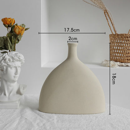 Minimalist ceramic vase on wooden table