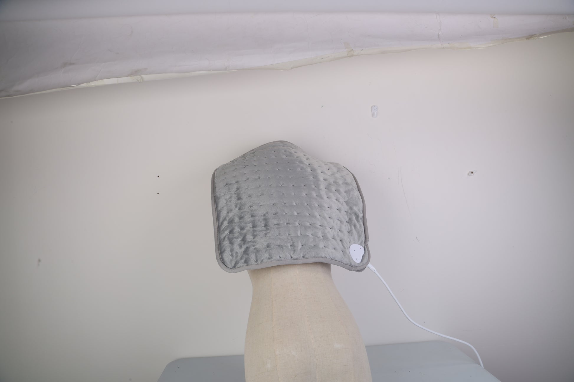Person using electric foot warmer at home